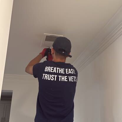 AirDuctVet residential and commercial cleaning quote: an AirDuctVet technician cleaning an indoor ventilation opening