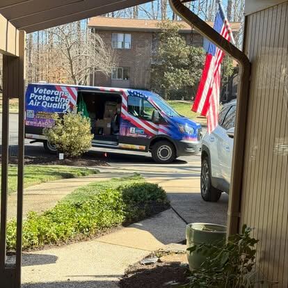 residential and commercial air duct cleaning: AirDuctVet service vehicles and ladder equipment at a real job