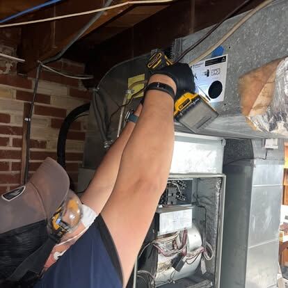 air duct cleaning guide: a technician cleaning an accessible HVAC system duct connection