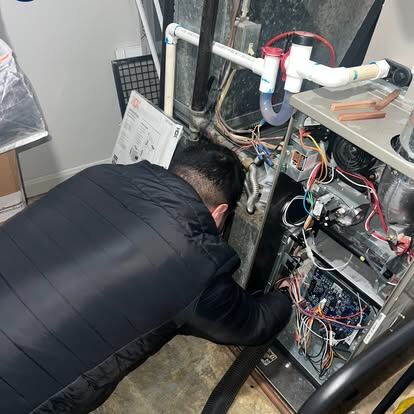 commercial air duct and dryer vent cleaning: an AirDuctVet technician working at residential HVAC equipment