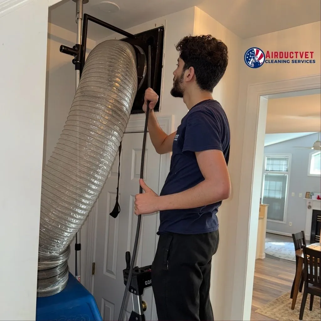 Technician from AirDuctVet performing trusted duct cleaning in Alexandria VA using professional equipment