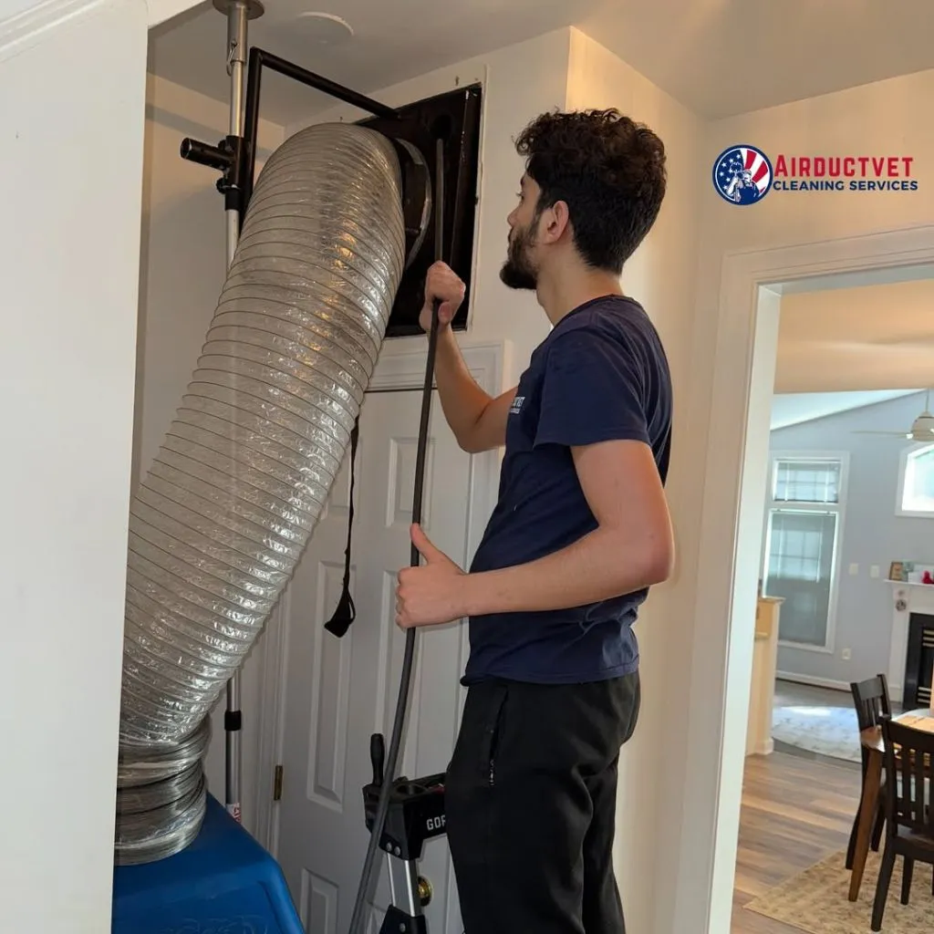 Technician using professional tools for dryer vent cleaning in Alexandria VA, ensuring deep lint removal and improved airflow.