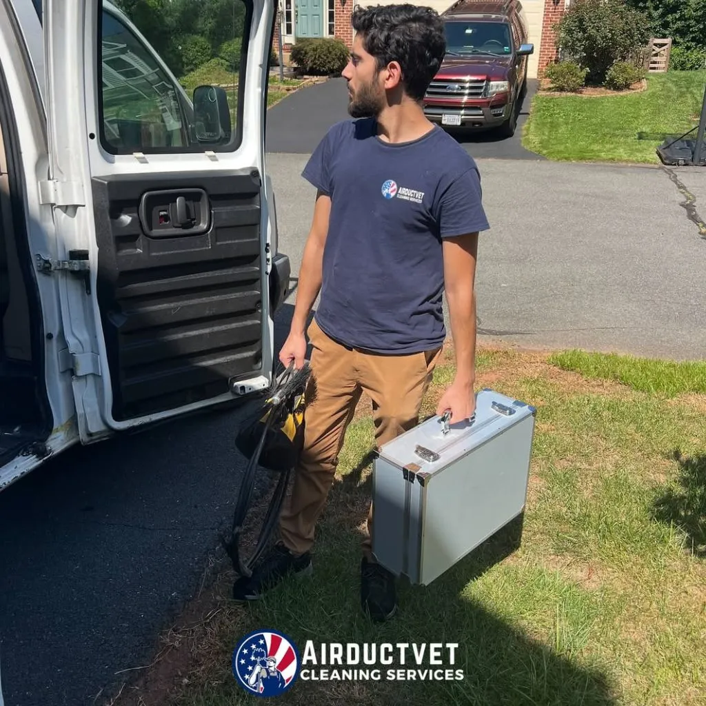 Air Duct Vet technician carrying professional tools for dryer vent cleaning in Alexandria VA, ready for on-site service.
