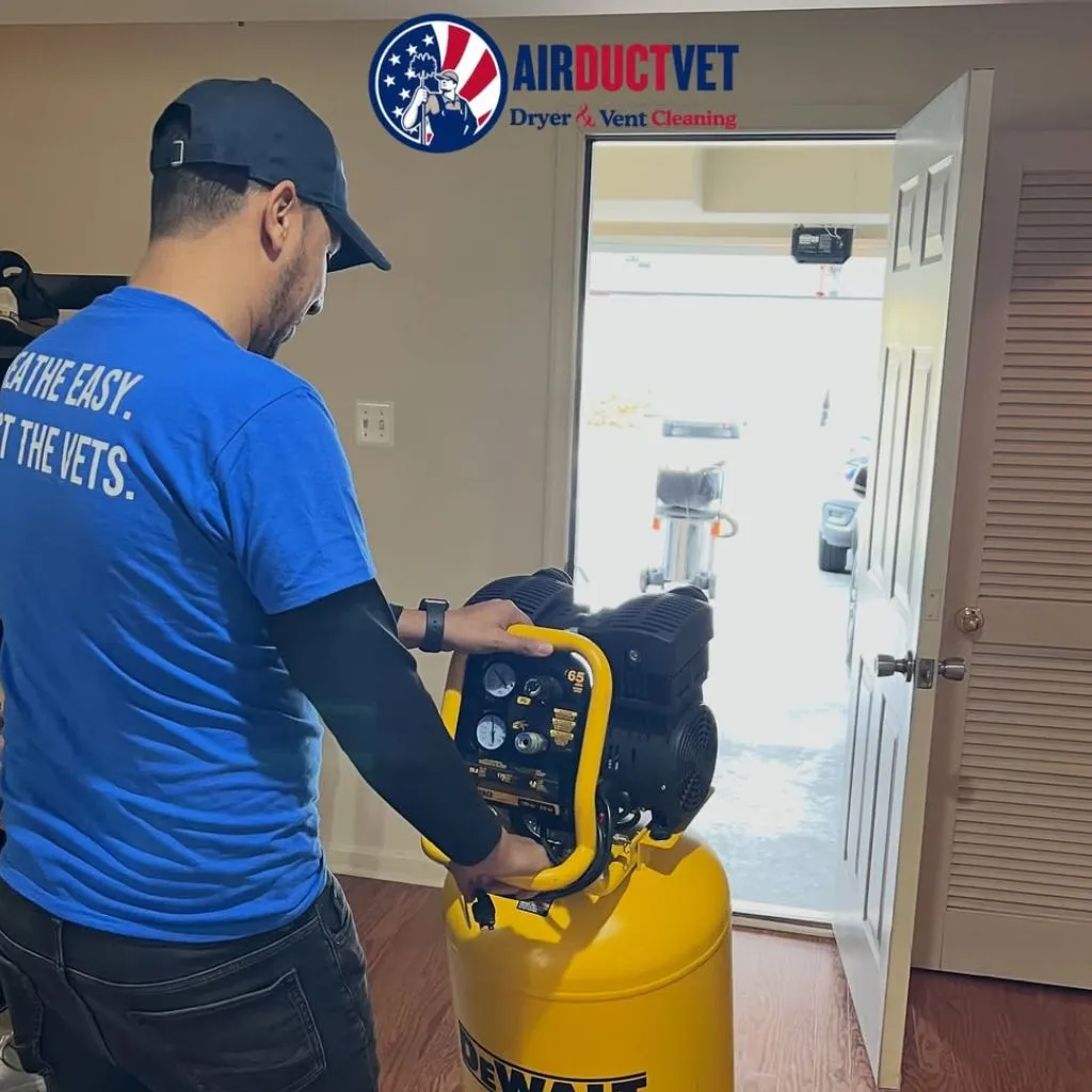 Overnight Dryer Fire Hazard in Alexandria prevention technician from Air Duct Vet operating DeWalt compressor for vent cleaning