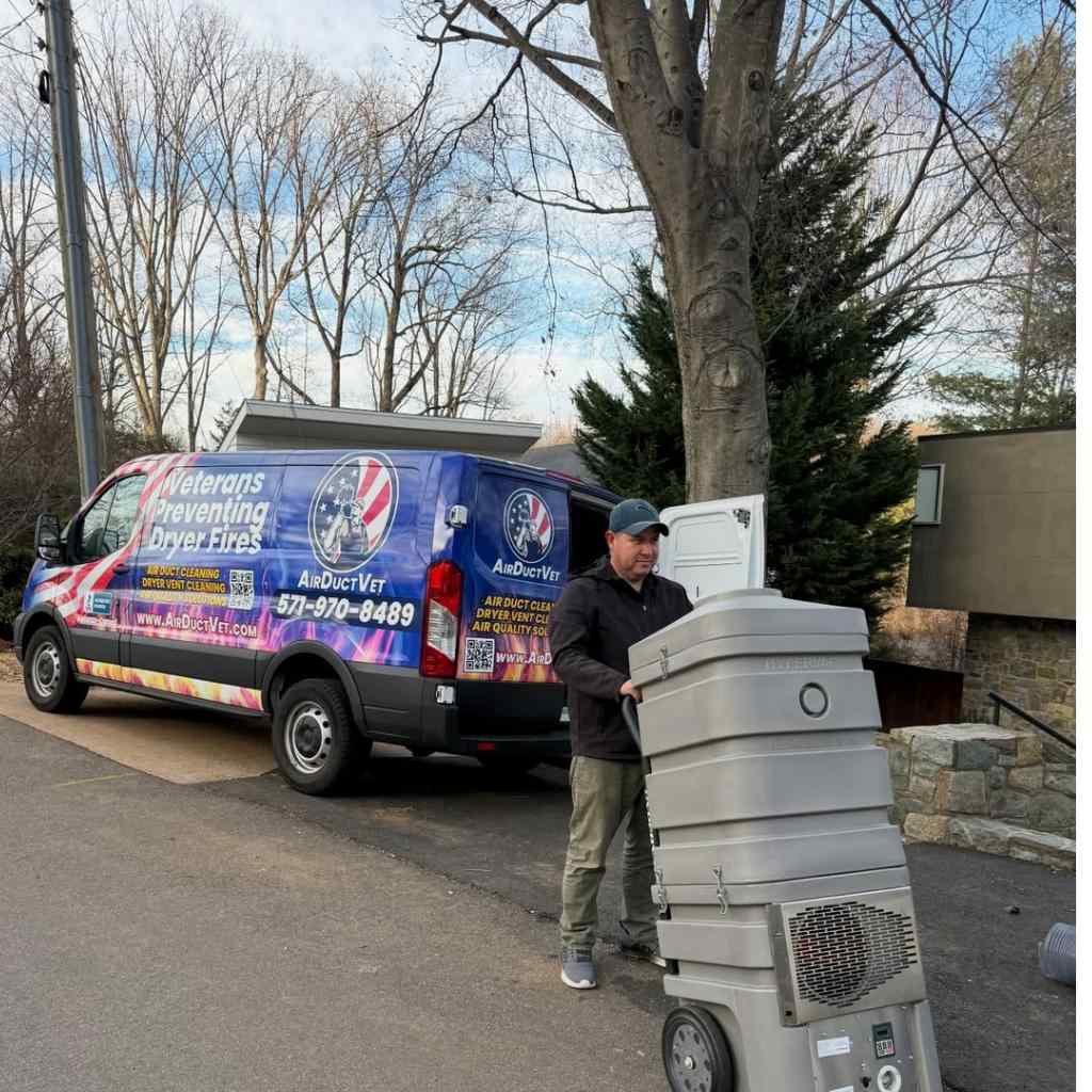 Air Duct Vet technician unloading industrial negative air machine to eliminate allergens in dryer vent in Alexandria.