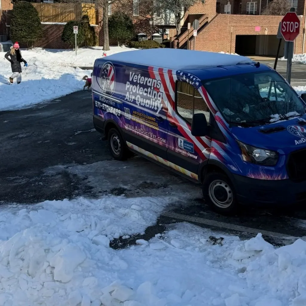 Air Duct Vet service van arriving in snowy winter conditions to provide professional asthma and air duct cleaning solutions.