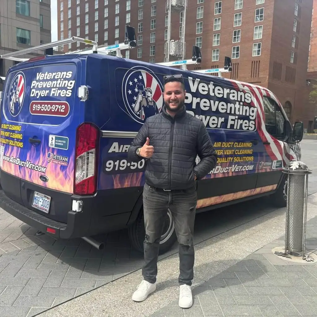 AirDuctVet team member giving thumbs up beside branded service van offering Raleigh Durham Triangle duct cleaning
