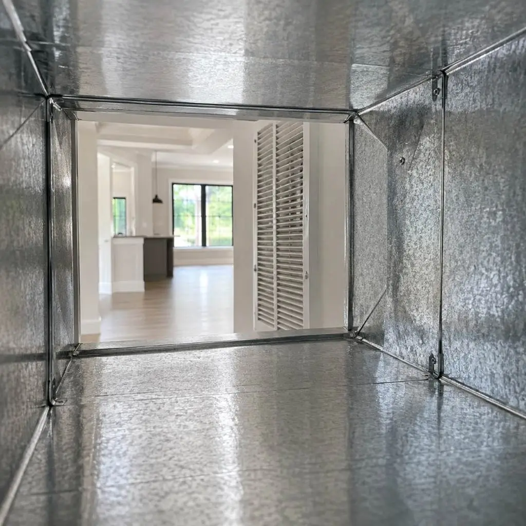 Interior view of a clean metal duct opening into a bright modern home, representing results of dryer vent cleaning Cary NC